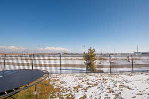 Snowy yard featuring a mountain view