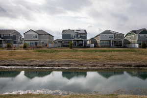 View of water feature featuring fence and a residential view
