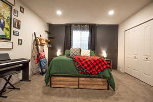 Bedroom featuring a closet and light carpet