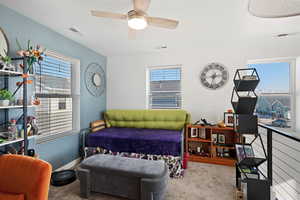 Bedroom featuring ceiling fan and light carpet