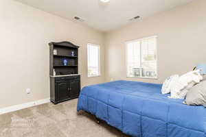 Bedroom with light colored carpet