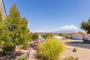 View of yard with a garage and a mountain view