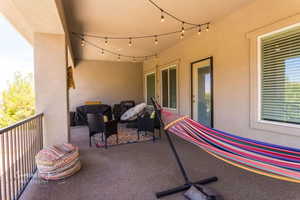 View of patio featuring a balcony