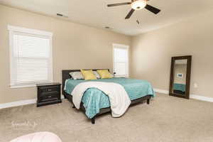 Carpeted bedroom with ceiling fan