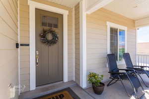 Doorway to property featuring a porch