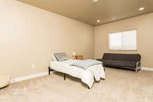 Carpeted bedroom featuring a textured ceiling