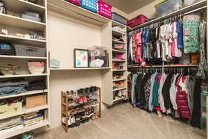 Walk in closet featuring carpet flooring