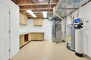 Basement with heating unit , water heater and work bench