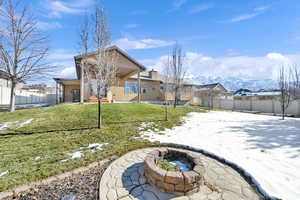 View of yard with a mountain view and an outdoor fire pit