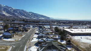 Snowy aerial view featuring a mountain view