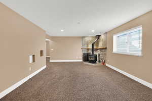 Living room with carpet and a wood stove