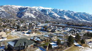 Snowy aerial view featuring a mountain view