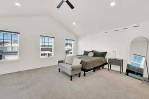 Bedroom with multiple windows, high vaulted ceiling, light carpet, and ceiling fan