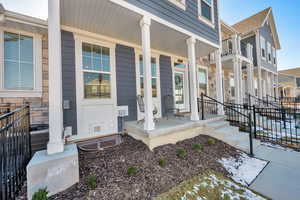 View of exterior entry featuring covered porch