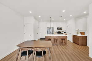 Dining room with light hardwood / wood-style floors