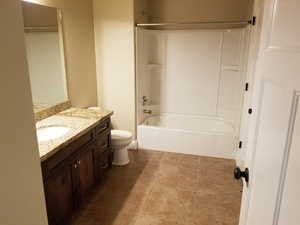 Full bathroom featuring shower / tub combination, vanity, and toilet