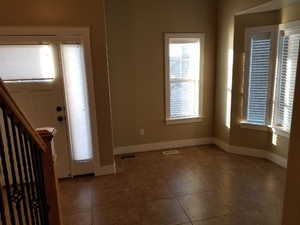 Entryway with dark tile patterned floors