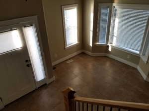 Foyer entrance with dark tile patterned flooring