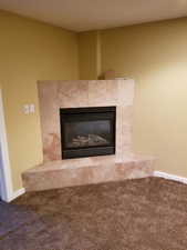 Interior details with carpet floors and a tile fireplace