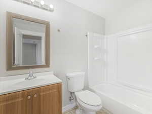 Bathroom featuring vanity, tile patterned floors, and toilet