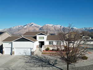 View of front of home with a garage and a mountain view