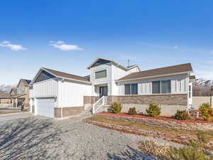 View of front of home featuring a mountain view and a garage