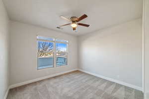 Empty room featuring carpet floors and ceiling fan