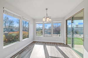 Unfurnished sunroom with a chandelier