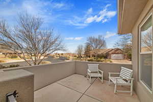 View of patio with a balcony