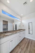 Bathroom with hardwood / wood-style flooring and vanity