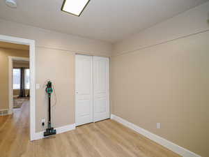 Interior space with light hardwood / wood-style floors and a closet