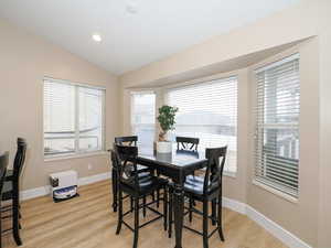 Dining space featuring lofted ceiling and light hardwood / wood-style floors