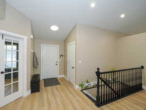 Foyer featuring lofted ceiling and light wood-type flooring