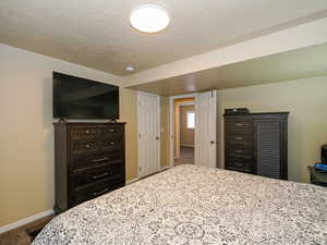 Bedroom with carpet flooring and a textured ceiling