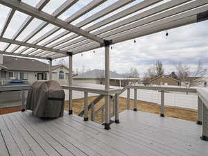 Wooden terrace featuring a grill, a pergola, and a jacuzzi