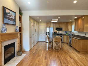 Kitchen featuring sink, a breakfast bar area, light hardwood / wood-style flooring, a kitchen island, and stainless steel appliances