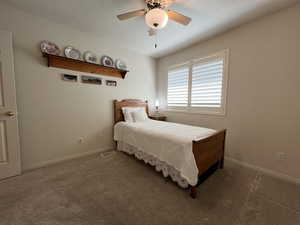 Carpeted bedroom with ceiling fan