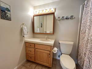 Bathroom with tile patterned flooring, vanity, and toilet