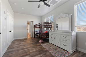 Bedroom with multiple windows, dark wood-type flooring, and ceiling fan