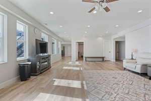 Living room featuring light hardwood / wood-style floors and ceiling fan