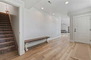 Entrance foyer featuring ceiling fan and light wood-type flooring