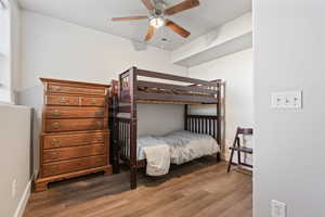 Bedroom with ceiling fan and wood-type flooring