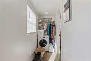 Laundry room featuring dark hardwood / wood-style floors and washer / clothes dryer