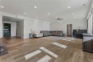 Unfurnished living room featuring light hardwood / wood-style floors and ceiling fan