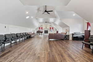 Interior space with lofted ceiling and dark wood-type flooring