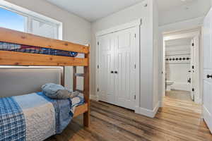 Bedroom with wood-type flooring and a closet