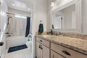 Full bathroom featuring vanity, tile patterned flooring, shower / bath combination with curtain, and toilet