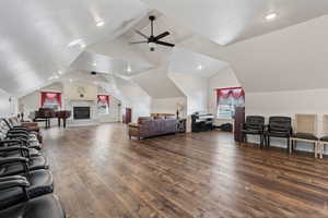 Bedroom featuring dark wood-type flooring and lofted ceiling