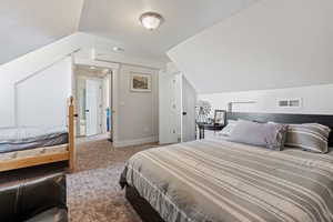 Bedroom with lofted ceiling and carpet