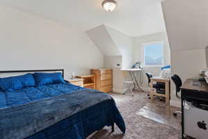 Bedroom featuring vaulted ceiling and carpet flooring